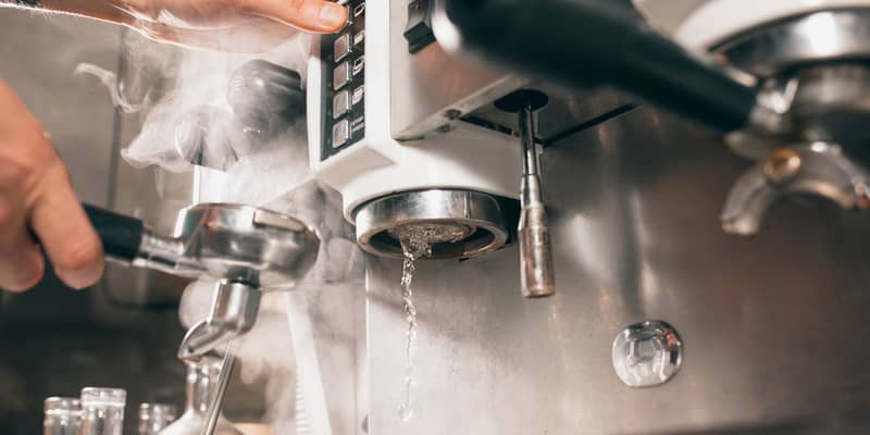 Maintenance, cleaning of coffee machine. Hot steam and water