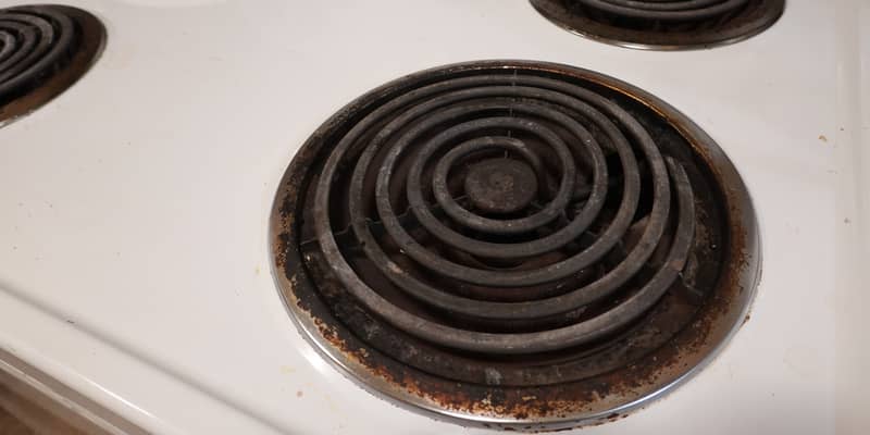 Close up the electric coil stove top in the kitchen