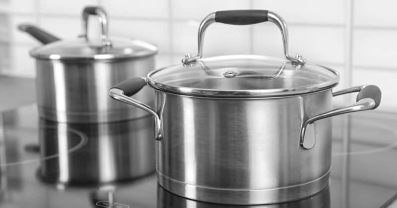 Metal saucepan on electric stove in kitchen