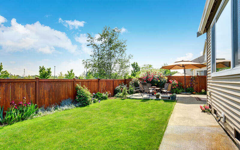 backyard garden and patio area on a concrete floor