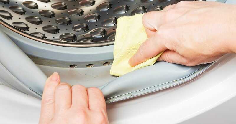 hands cleaning gasket of a front loader washing machine