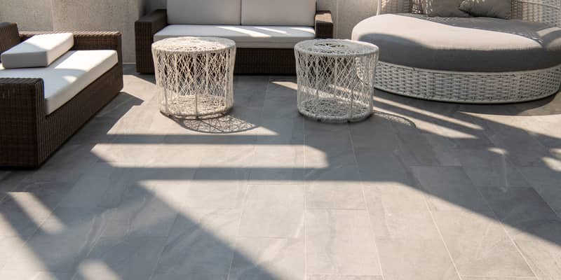 Outdoor terrace area with grey floor tile with sitting area