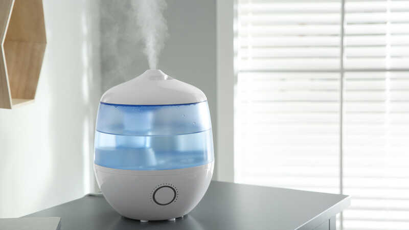 Modern air humidifier on table indoors. 