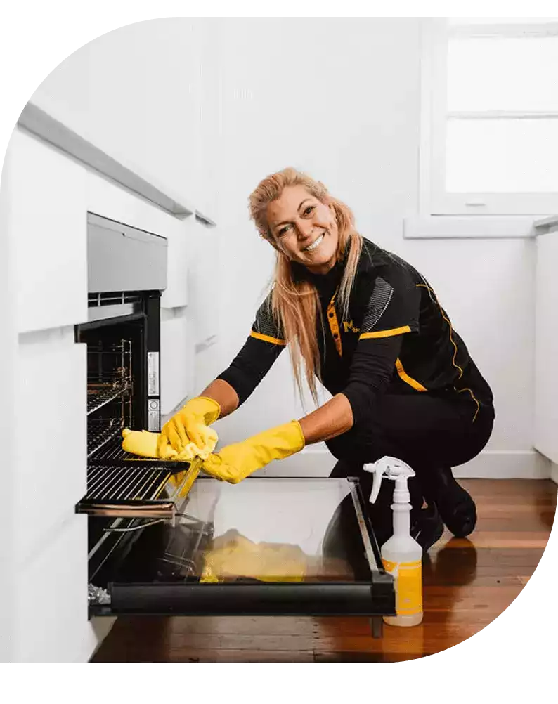End-of-lease-cleaning-banner-image Maid2Match team cleaning an oven and smiling
