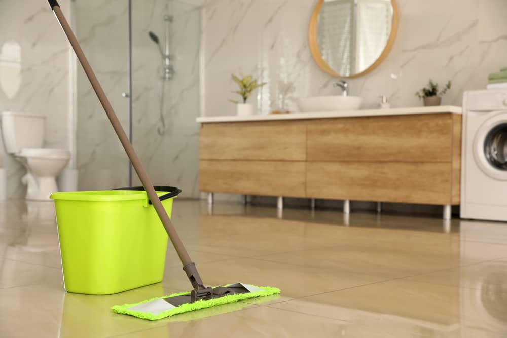 Bucket and mop on floor at home for cleaning