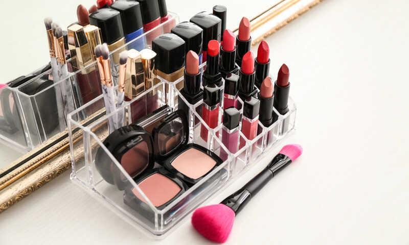 lipsticks and other cosmetic products in an acrylic makeup organizer