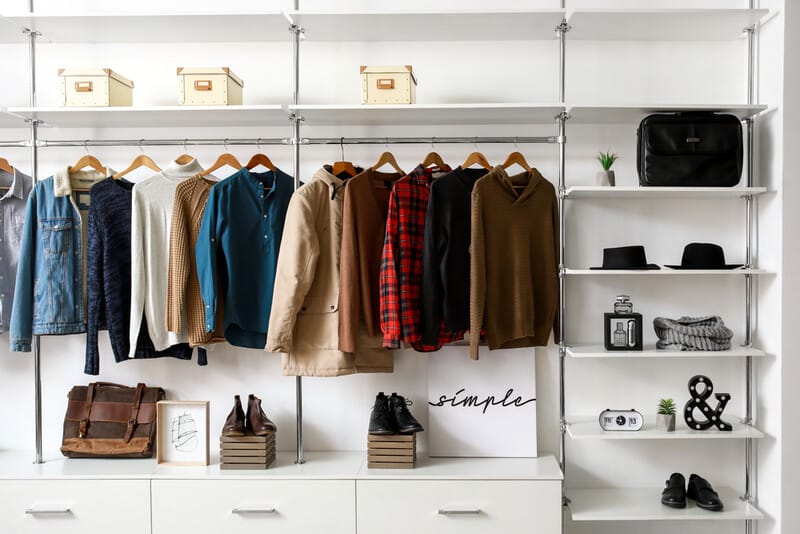 Modern wardrobe with stylish winter clothes and accessories