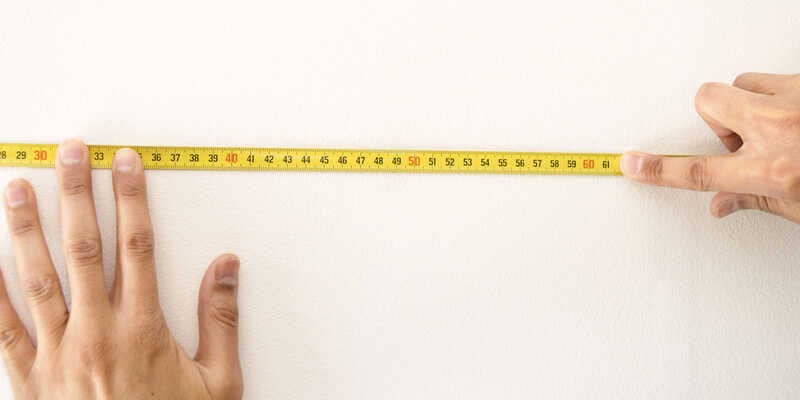 Closeup of a measuring tape in wall 