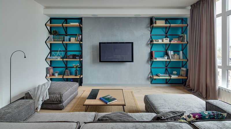 Room in a modern style with gray walls with blue niches and a parquet with carpet on the floor