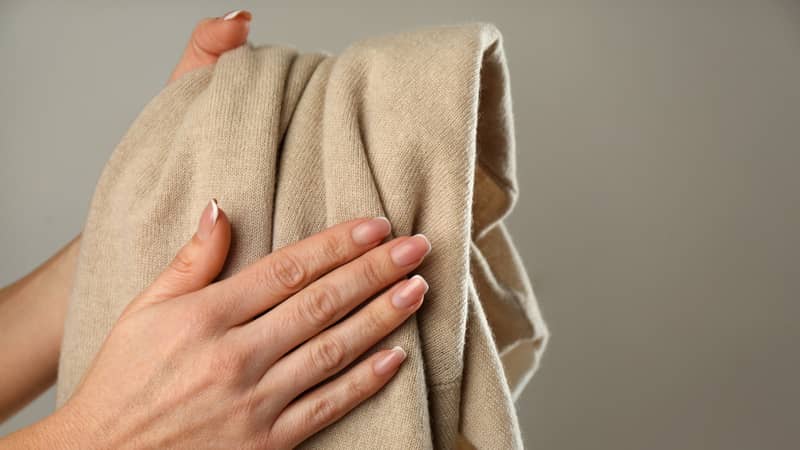 woman hands holding cashmere clothing