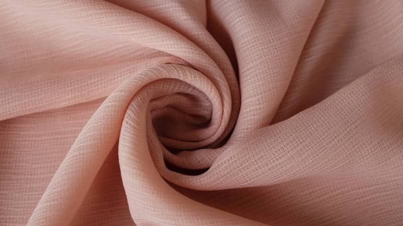 Soft beige color viscose fabric texture seamless with beautiful closeup detail fabric.