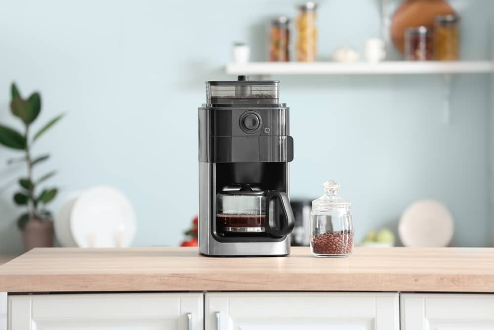 Modern coffee machine on table in kitchen