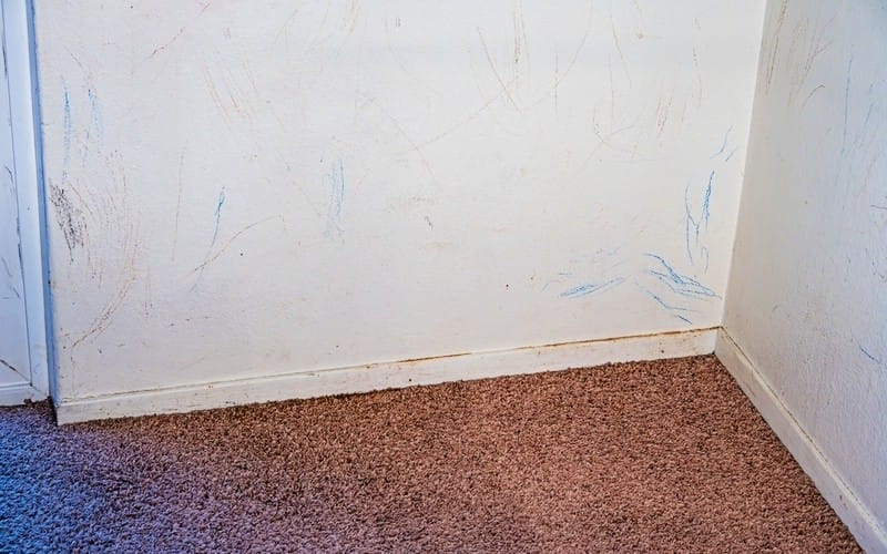 Interior white walls covered in red and blue crayon marks