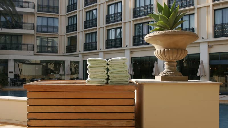 Towels on a bench beside a pool