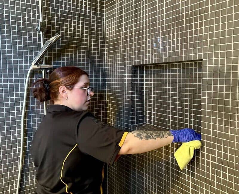 Paris cleaning the shower area