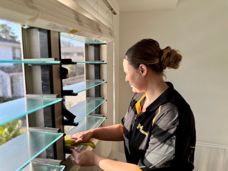 professional cleaner cleaning Louvre windows