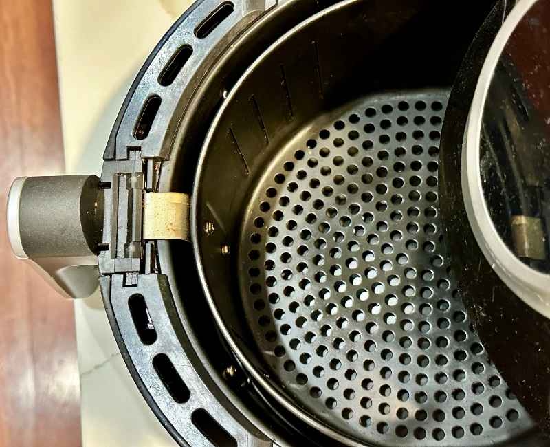 Open air fryer unit with basket and tray up close
