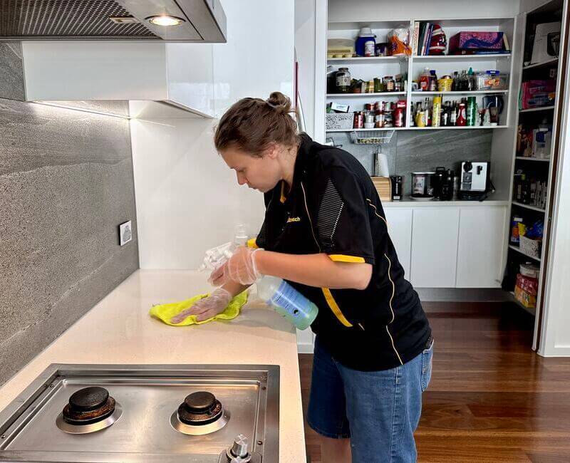 Maid2Match clener Acama wiping the benchtop
