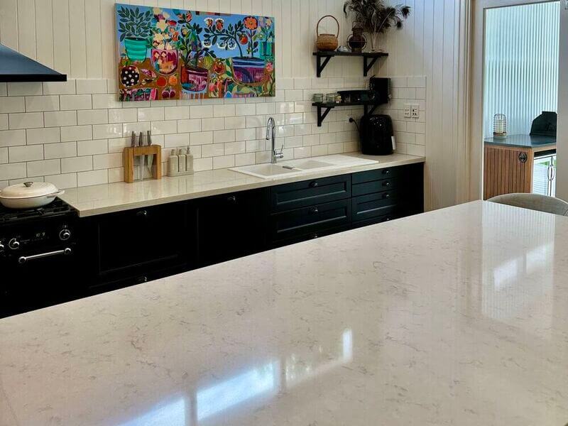 clean kitchen with a shiny stone benchtop