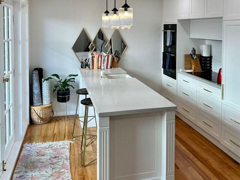 modern kitchen with a clean stone benchtop in the middle