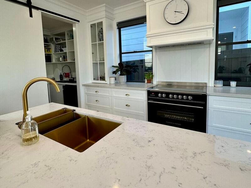 clean kitchen with a polished stone benchtop