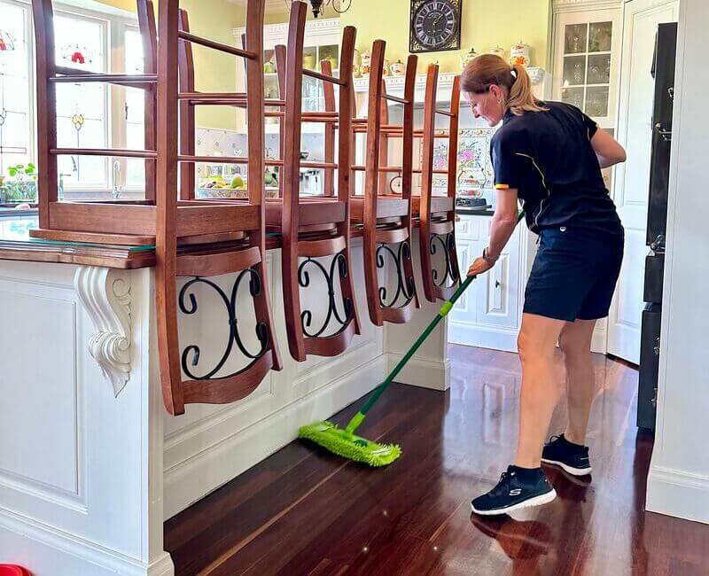 Maid2Match professional cleaner using dust mop