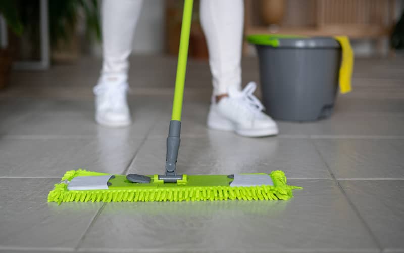 dust mop being used by a professional cleaner