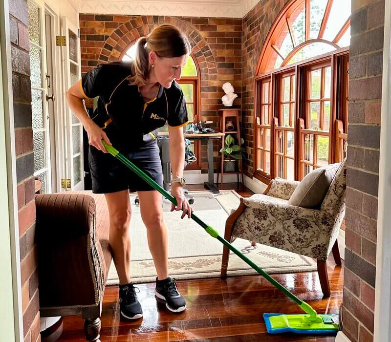 professional cleaner using flat mop for cleaning floors