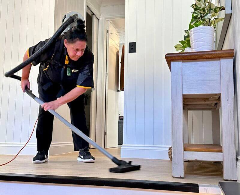 Janet vacuuming the floor