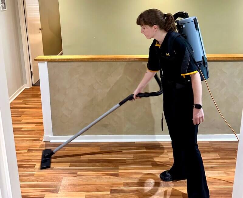 Kayleigh cleaning the floor with vacuum cleaner