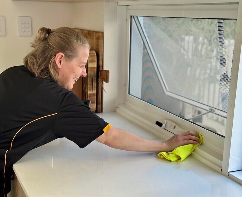 professional-house-cleaner-cleaning-window Maid2Match house cleaning, Brisbane professional cleaner Nicole cleaning the window