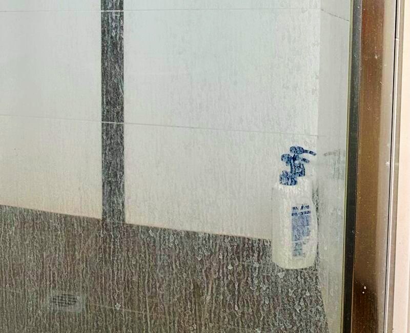 limescale buildup on shower glass screen