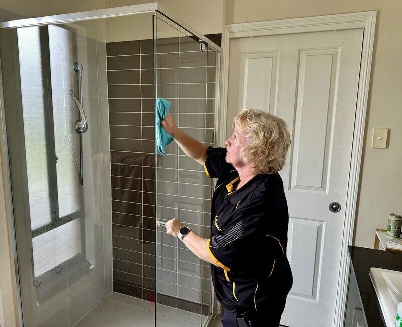 Maid2Match Gold Coast house cleaner Nicola cleaning shower glass