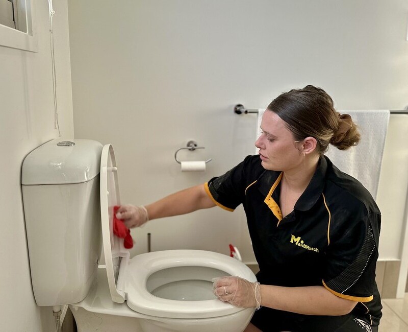 Maid2Match Brisbane professional house cleaner cleaning the toilet seat