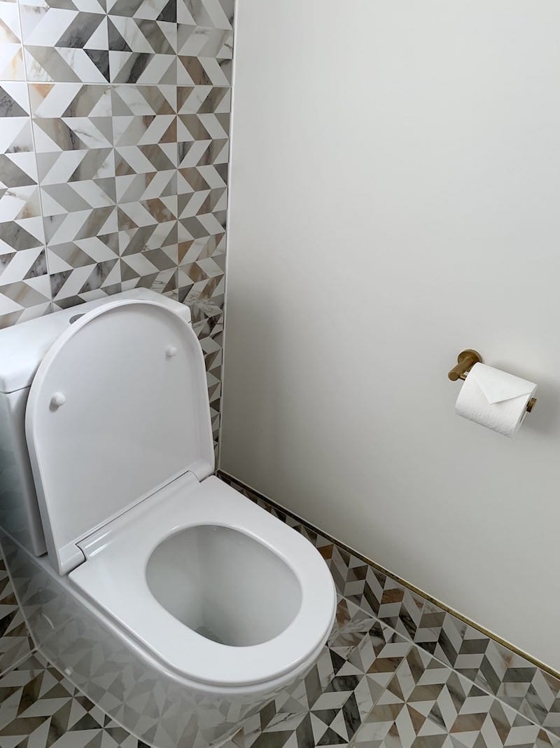 clean toilet with folded toilet paper