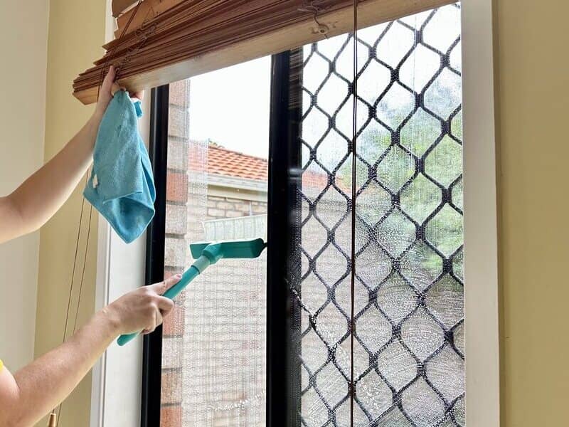 house cleaner cleaning windows