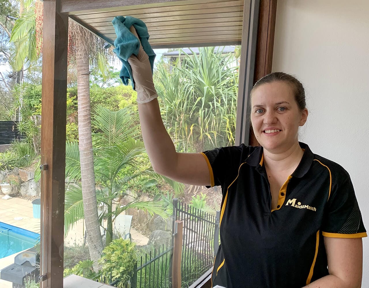 Nikita smiling while cleaning the windows Maid2Match Nikita smiling while cleaning customer's windows