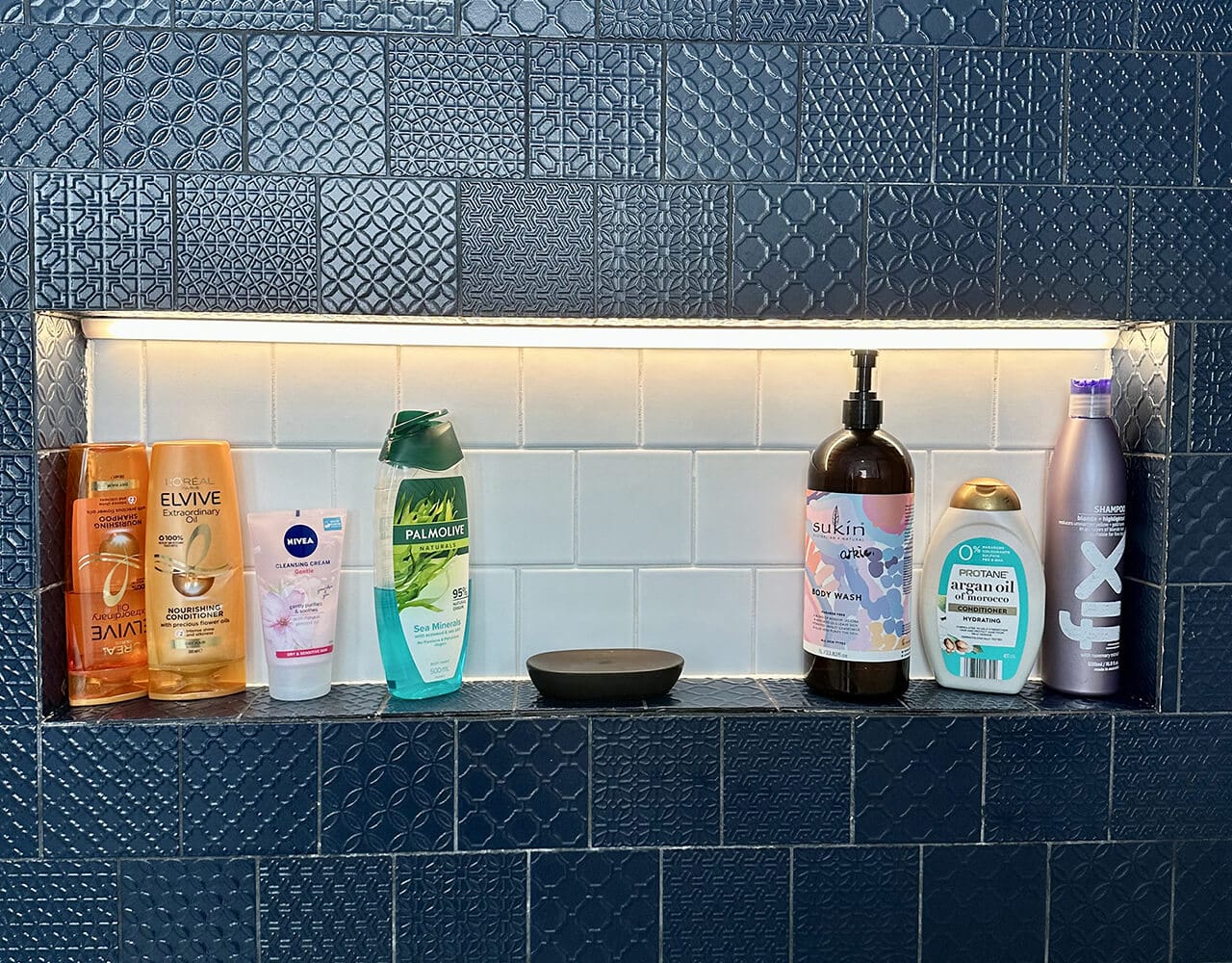 organised shower shelf shower shelf of shampoos and body wash cleaned and organised
