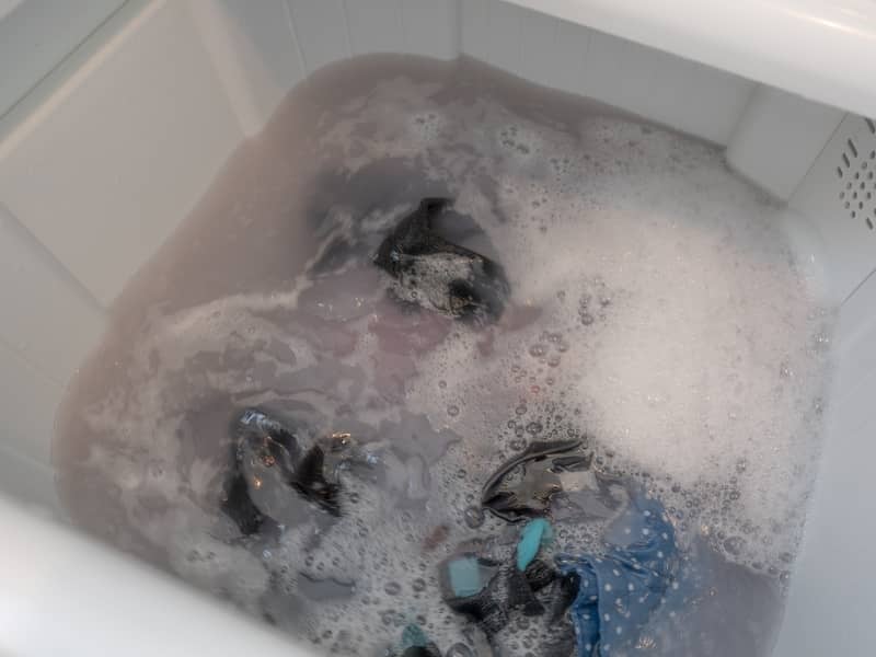 Laundry being washed in a top load washing machine