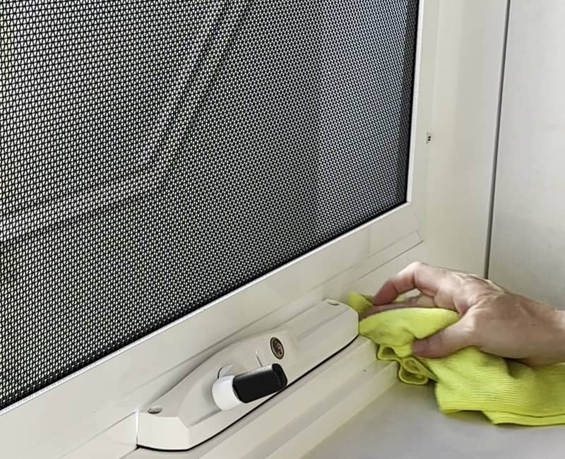 house-cleaner-cleaning-window-with-fly-screen Professional cleaner cleaning window with fly screen