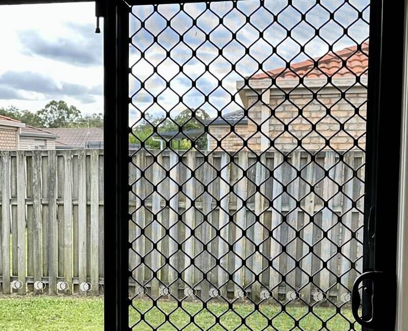 security screen installed along glass door