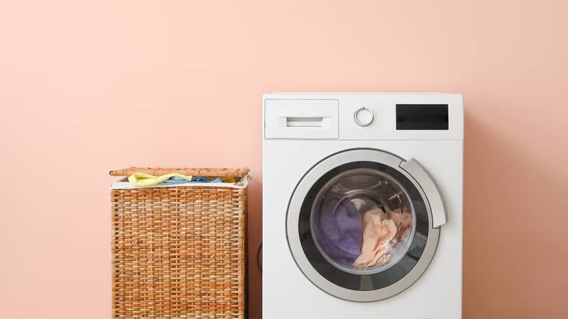 Washing machine and basket with laundry near color wall