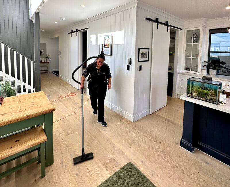 professional-cleaner-Janet-cleaning-floating-floors Maid2Match professional house cleaner Janet vacuuming the floorboards