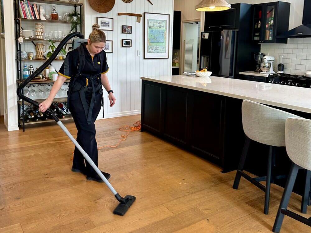 Kate-Lyn-vacuuming-floating-floorboards Professional house cleaner Kate-Lyn vacuuming flaoting floors