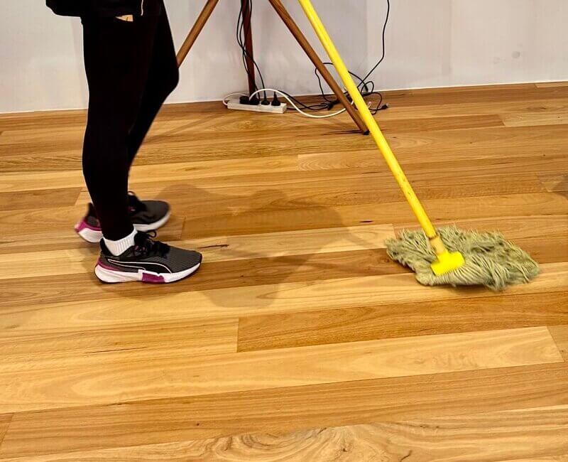 Maid2Match-cleaner-mopping-floating-floor professional cleaner mopping floating floors with yellow string mop