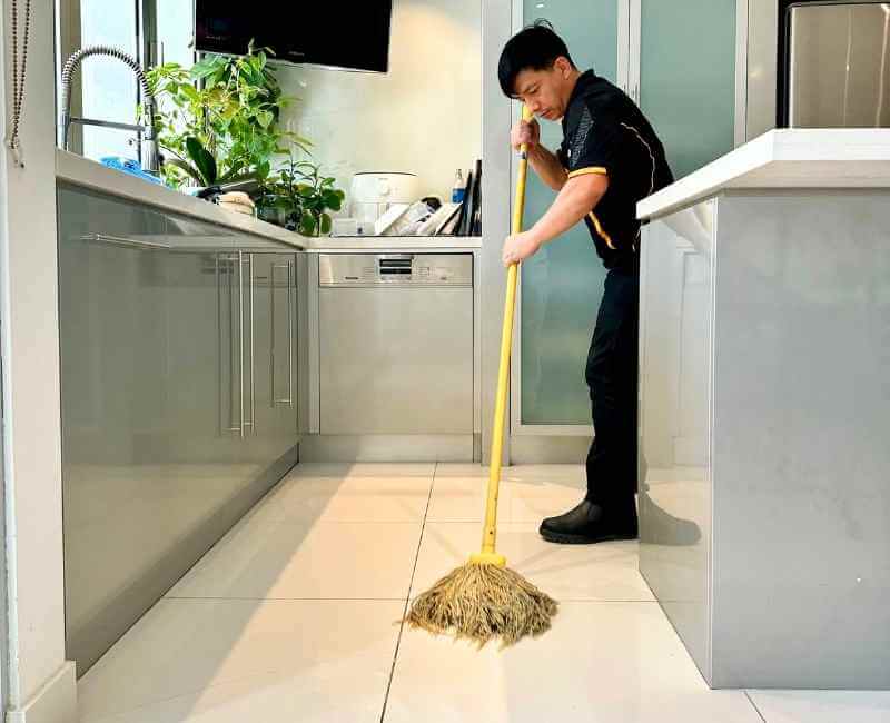 Maid2Match Brisbane house cleaner Ugyen mopping floor tiles