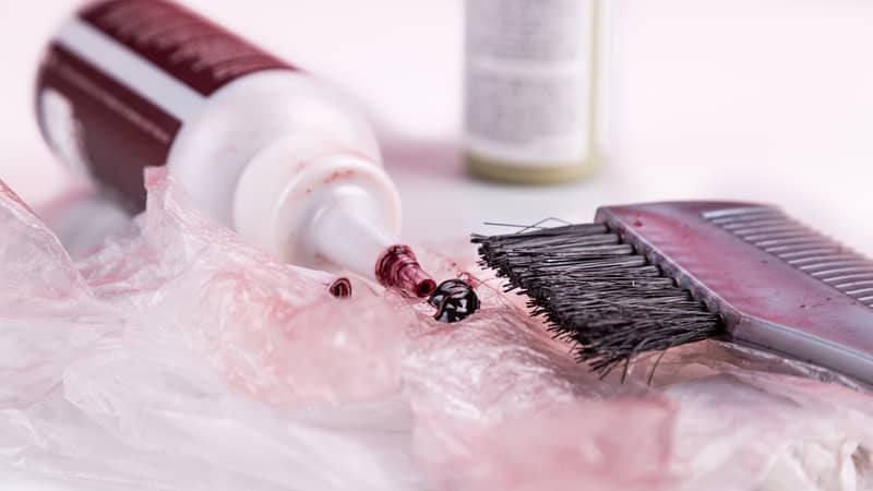 Close-up of chemical hair color dye set with comb and brush