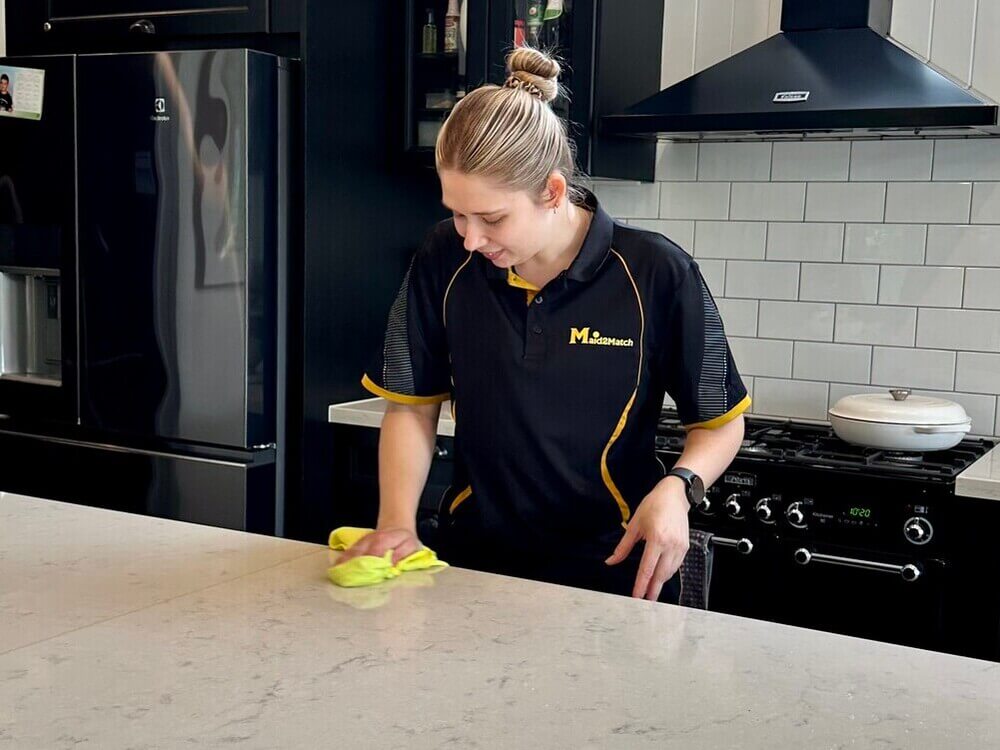 Professional cleaner Kate-lyn cleaning the benchtop