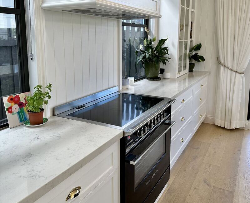 clean kitchen with marble bench tops and surfaces