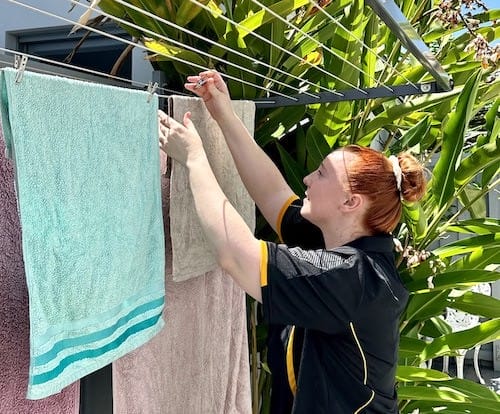 Hollie hanging laundry outside